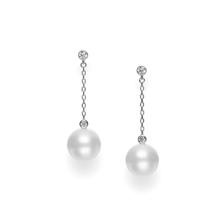 An elegant and modern drop-earring design that features a single Mikimoto cultured pearl and diamond on a white gold chain.
